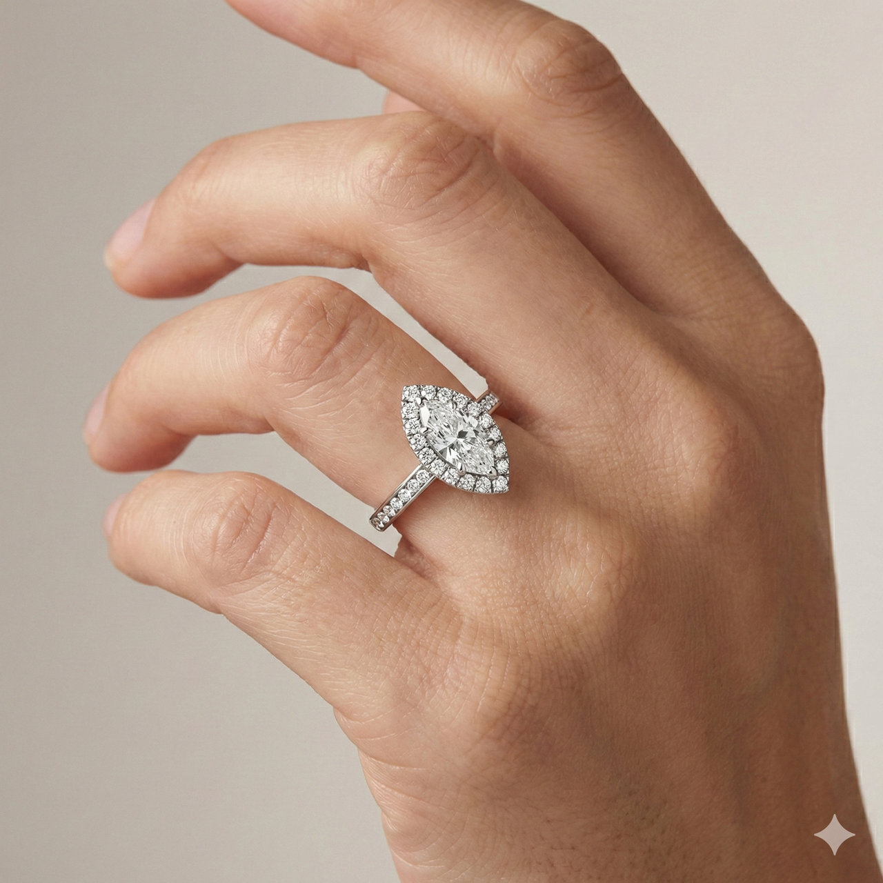 Marquise cut diamond engagement ring in 14k white gold with a X band and X setting on a hand