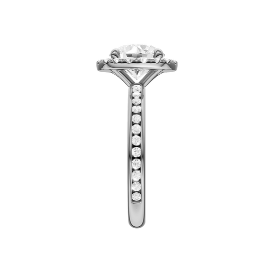 A side view of the Round cut diamond engagement ring in platinum with a diamond channel band and halo setting