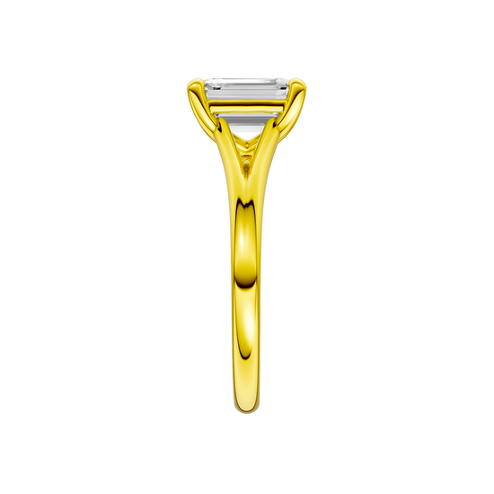A side view of the Emerald cut diamond engagement ring in 14k yellow gold with a plain band and split setting