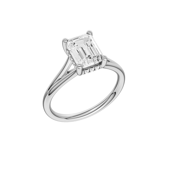 A three-quarter view of the Emerald cut diamond engagement ring in 14k white gold with a plain band and hidden halo setting