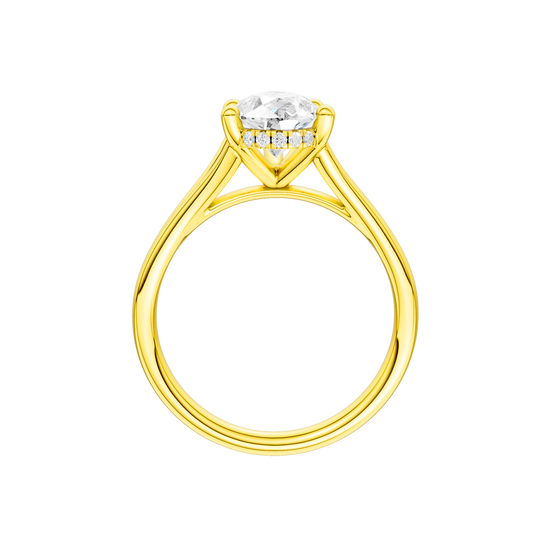 A profile view of the Pear cut diamond engagement ring in 14k yellow gold with a plain band and cathedral setting
