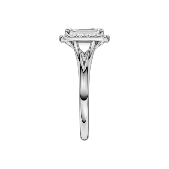 A side view of the Emerald cut diamond engagement ring in 14k white gold with a plain band and halo setting