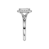 A side view of the Emerald cut diamond engagement ring in 14k white gold with a plain band and halo setting