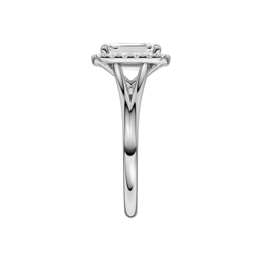 A side view of the Emerald cut diamond engagement ring in 14k white gold with a plain band and halo setting