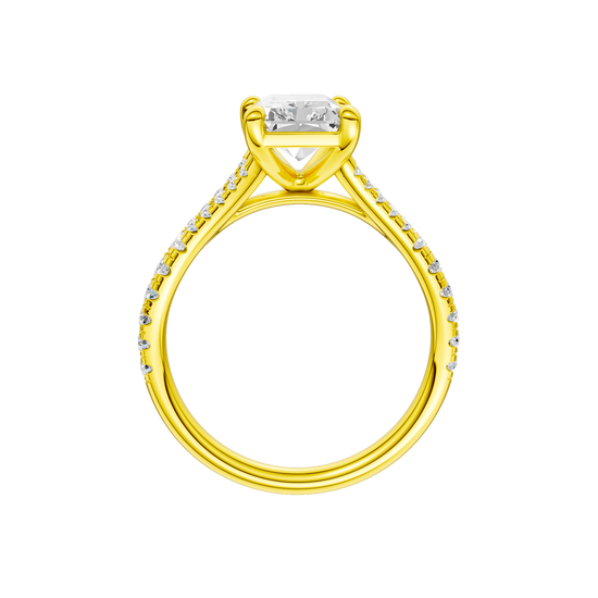 A profile view of the Radiant cut diamond engagement ring in 14k yellow gold with a diamond band and solitaire setting