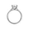 A profile view of the Elongated Cushion cut diamond engagement ring in platinum with a diamond band and hidden halo setting