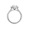 A profile view of the Elongated Cushion cut diamond engagement ring in platinum with a prong band and halo setting