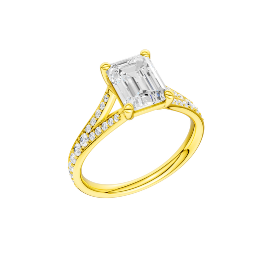 A three-quarter view of the Emerald cut diamond engagement ring in 14k yellow gold with a diamond channel band and split setting
