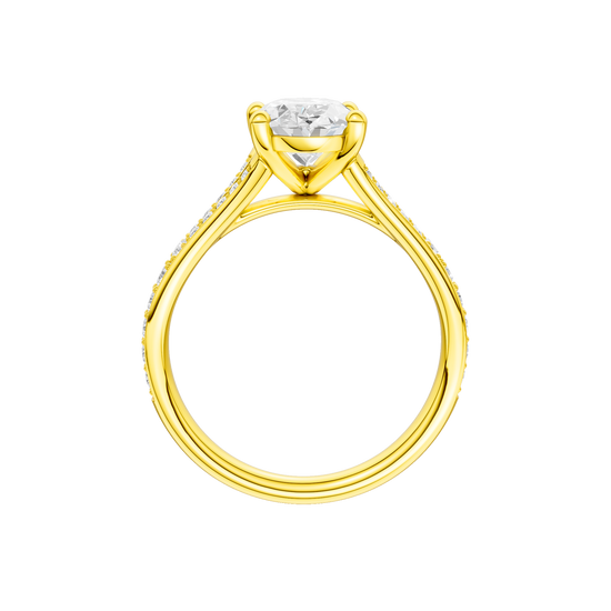 A profile view of the Oval cut diamond engagement ring in 14k yellow gold with a diamond channel band and split setting