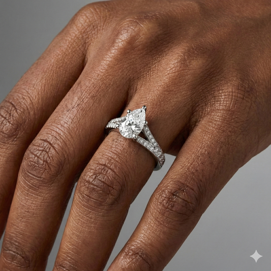Pear cut diamond engagement ring in 14k white gold with a diamond channel band and split setting on a hand