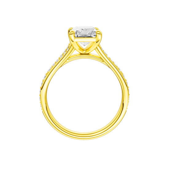 A profile view of the Radiant cut diamond engagement ring in 14k gold gold with a diamond channel band and split setting