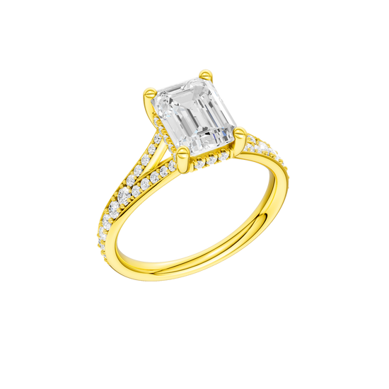 A three-quarter view of the Emerald cut diamond engagement ring in 14k yellow gold with a diamond channel band and split setting