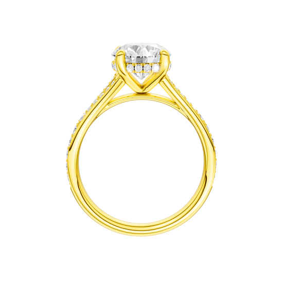 A profile view of the Round cut diamond engagement ring in 14k yellow gold with a channel band and hidden halo setting