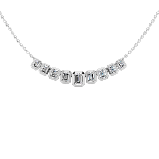 Zoomed in front view of a delicate graduated emerald-cut diamond necklace in white gold, featuring smaller step-cut diamonds arranged in a refined curved silhouette on a fine chain.