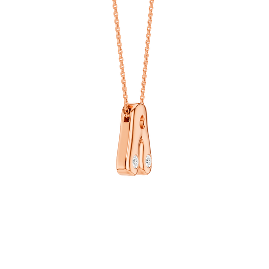 A high-polish 14k rose gold initial pendant by Amorati featuring star and geometric insets with shimmering round-cut lab-grown diamonds. Amorati’s signature F O U R T E E N T H Collection