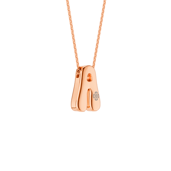 A high-polish 14k rose gold initial pendant by Amorati featuring star and geometric insets with shimmering round-cut lab-grown diamonds. Amorati’s signature F O U R T E E N T H Collection
