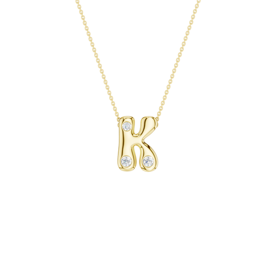 Modern 14k yellow gold bubble letter K initial necklace studded with three brilliant round-cut flush-set white diamonds on a delicate cable chain.