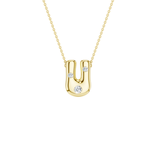 A product shot of a yellow gold necklace featuring a fine cable chain attached to the top curves of a smooth, bubble-font letter 'U' pendant. The polished gold 'U' is embellished with three sparkling, flush-set round diamonds: one situated on each of the vertical stems, and a slightly larger one centered on the bottom curve