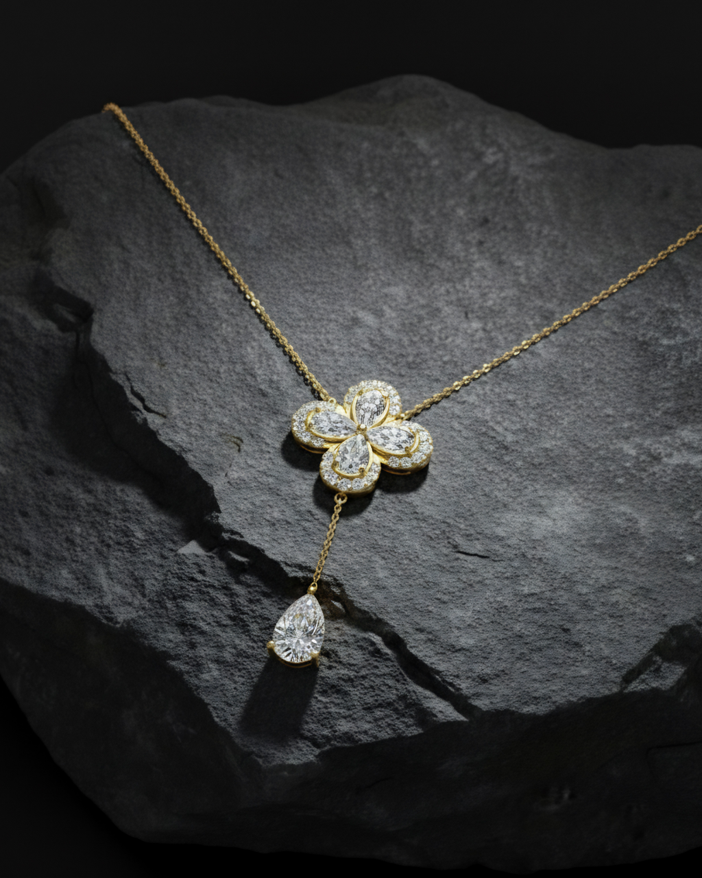 Front view of a yellow gold floral diamond necklace featuring a pear-cut diamond flower pendant with matching diamond accents along a delicate yellow gold chain.