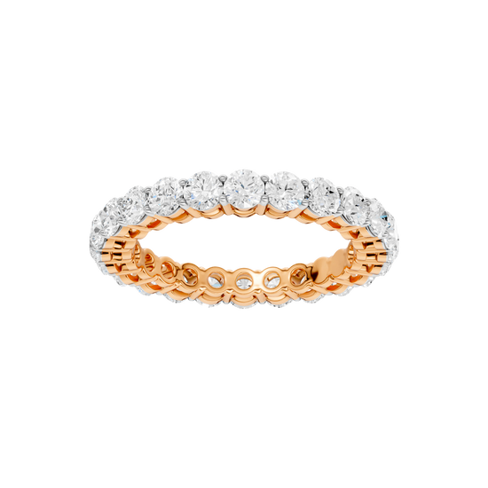 A top-down view of a 14K rose gold eternity band with a continuous line of brilliant oval jewels.