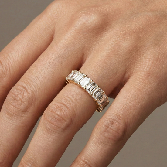 A breathtaking 14k yellow gold 2/3 eternity wedding band featuring 3.0 total carats of shimmering emerald-cut lab-grown diamonds on hand.