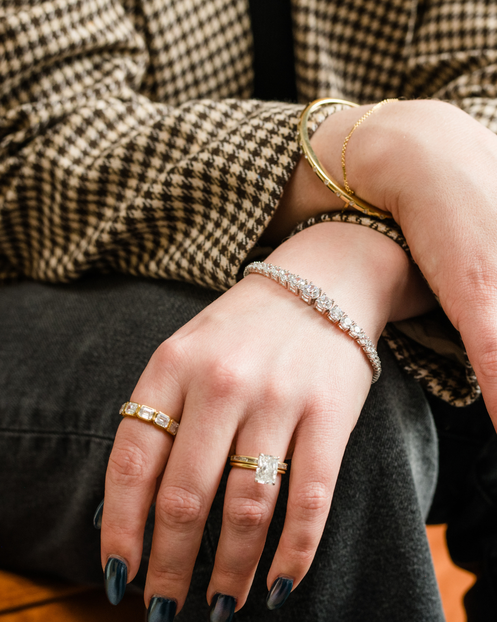 Yellow gold Amorati Skyline Diamond Mosaic Ring worn on a model's index finger, styled with a diamond engagement ring and a diamond tennis bracelet.
