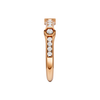 A side-profile view of a 14K rose gold geometric ring, showing the fluid band and the bezel-set diamonds.