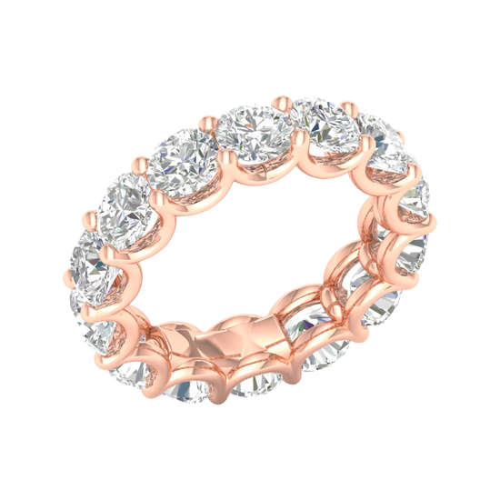 An angled view of a 14K rose gold ring, showcasing the seamless brilliance of the bezel-set jewels.
