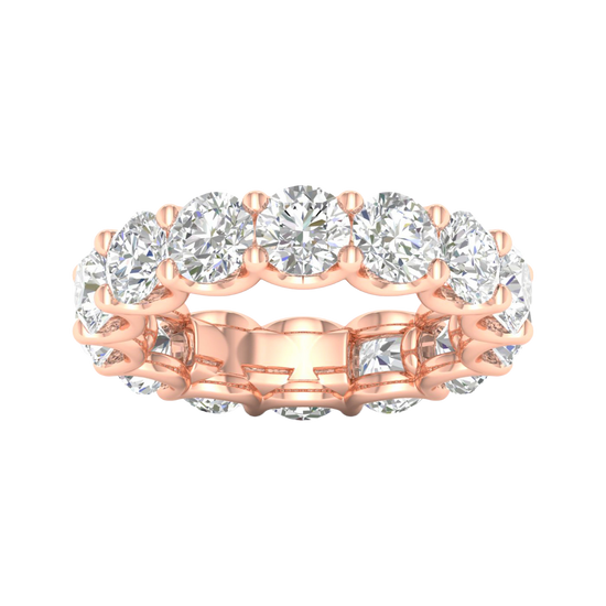A top-down view of a 14K rose gold wide band ring with a continuous row of large, bezel-set round jewels.