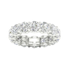 A top-down view of a 14K white gold wide band ring with a continuous row of large, bezel-set round jewels.