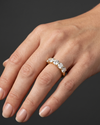 Lifestyle view of a model wearing a luxurious 14k yellow gold five-stone diamond ring featuring a row of large, uniform round brilliant-cut diamonds.