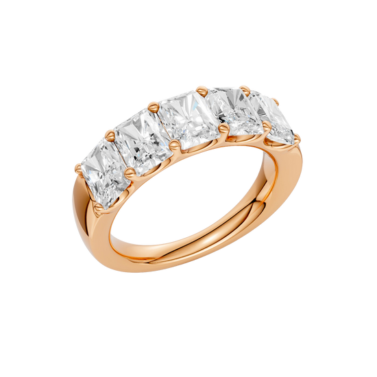 An angled view of a 14K rose gold wide band ring, showcasing the clean, bold lines of the tapered diamonds.