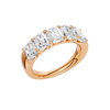 An angled view of a 14K rose gold wide band ring, showcasing the clean, bold lines of the tapered diamonds.