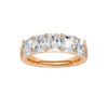 A top-down view of a 14K rose gold wide band ring with five horizontally-set emerald-cut diamonds, with the center one being larger.
