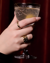 A lifestyle view of A high-polish 14k yellow gold dome ring by Amorati featuring scattered star and geometric insets with shimmering round-cut diamonds. Amorati’s signature F O U R T E E N T H Collection.