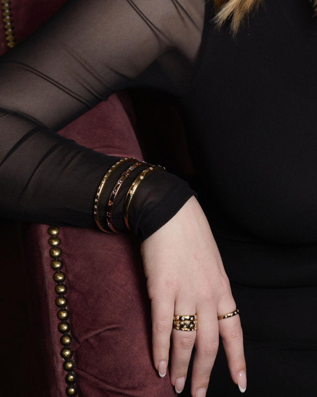 A slim 14k yellow gold stackable ring by Amorati featuring delicate star-shaped insets with shimmering round lab-grown diamonds, elegantly displayed on a model’s hand. Amorati’s signature F O U R T E E N T H Collection.