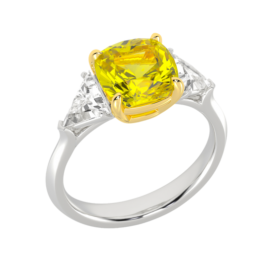Angled view of a white gold three-stone ring featuring a with 3.50ct IGI Certified Center Yellow Canary Cushion lab grown VS+ E-F elite stone and an additional .66 cttw trillion VS+ E-F side stones for a total of 4.16 cttw of great value and ships insured for free.