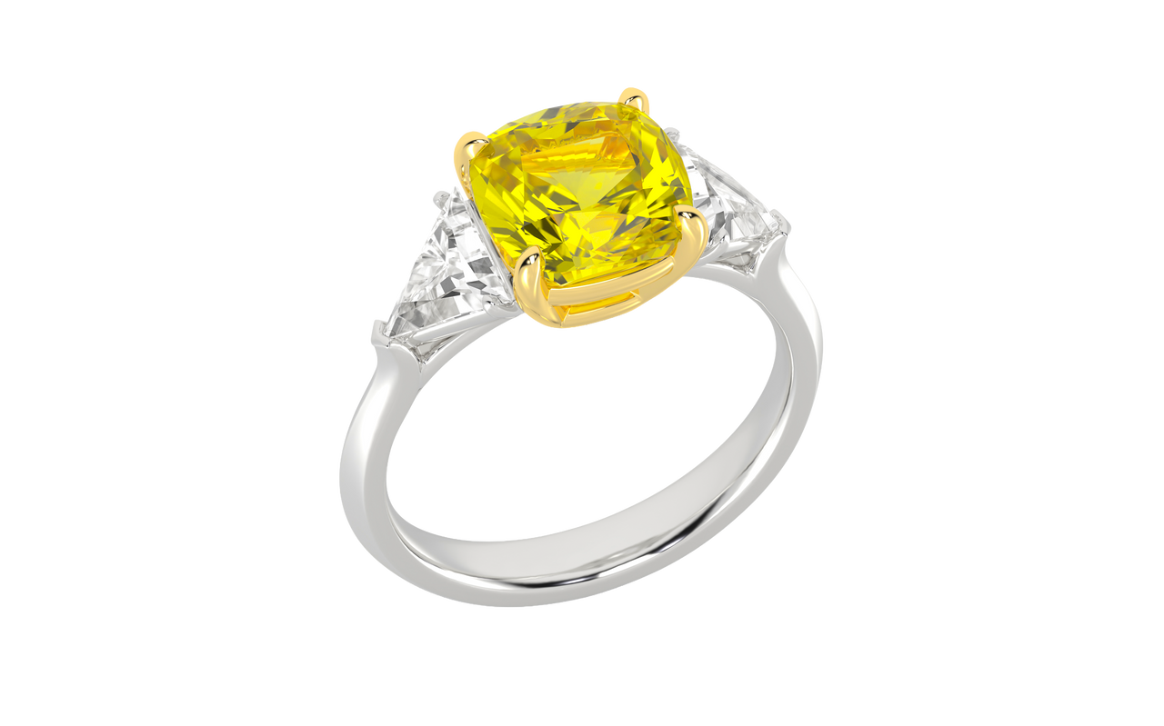Angled view of a white gold three-stone ring featuring a with 3.50ct IGI Certified Center Yellow Canary Cushion lab grown VS+ E-F elite stone and an additional .66 cttw trillion VS+ E-F side stones for a total of 4.16 cttw of great value and ships insured for free.