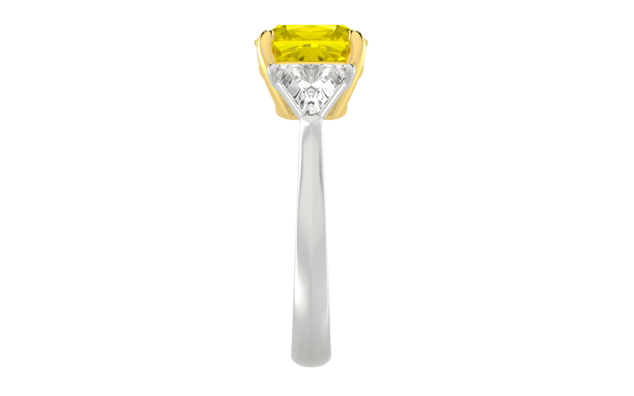 Side view of the Trilogy Engagement Ring which is highlighting the elevated brilliant 4.16 Cttw Soleil Cushion Canary Trilogy Diamond Ring with 3.50ct IGI Certified VS+ Vivid Center Yellow Canary Cushion Stone and an additional .66 cttw Trillion Side Stones