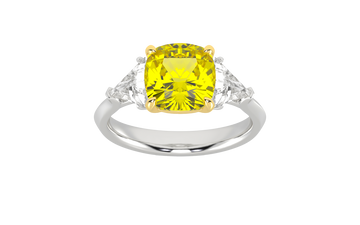 Top view of a white gold three-stone ring showcasing a gorgeous 4.16 Cttw Soleil Cushion Canary Lab-Grown Diamond that is a 3.50ct IGI Certified Center and Trillion Side Stones that are 0.33 ct weight each for a total of 0.66 cttw all stones are VS+ and E-F color set in 14 kt gold.