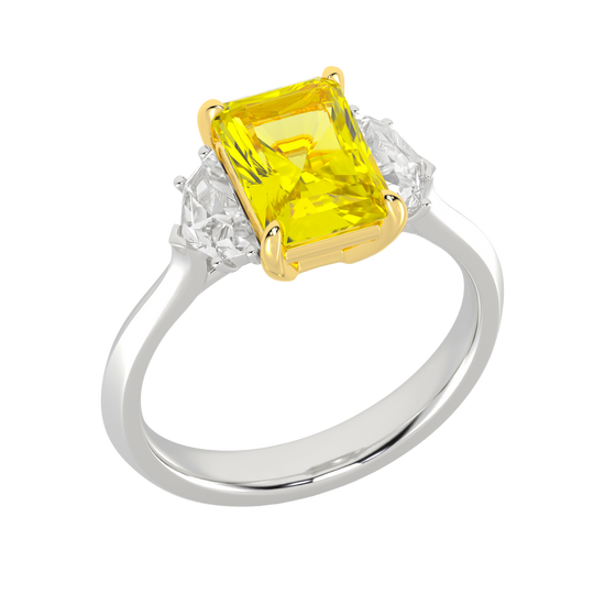 Angled view of a white gold three-stone ring featuring a yellow diamond center with white diamond side stones and a polished band.