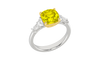 Angled view of a white gold ring featuring a yellow diamond center with white diamond accents and a polished band.