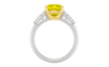 Front view of a white gold ring featuring a yellow diamond center with white diamond side stones in a polished setting.