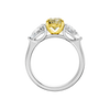 Front view of a white gold three-stone ring featuring a yellow diamond center flanked by pear-shaped white diamond side stones.