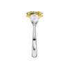 Side view of a white gold three-stone ring highlighting the elevated yellow diamond center and tapered pear-shaped white diamond accents.