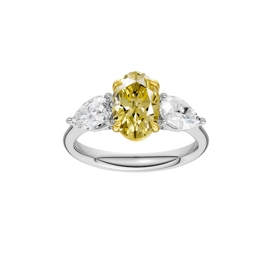 Top view of a white gold three-stone ring showcasing a yellow diamond center with pear-shaped white diamonds on each side.