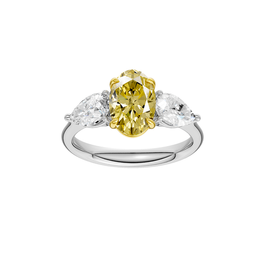 Top view of a white gold three-stone ring showcasing a yellow diamond center with pear-shaped white diamonds on each side.