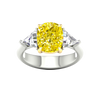 Top view of IGI Certified 4.0ct  VS+ Vivid Canary Yellow center lab grown diamond and .66 cttw of VS+ E-F diamond triangle side stones in a white and yellow gold setting.