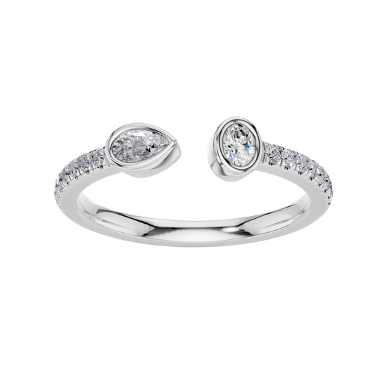 A top-down view of a 14K white gold bypass ring with a pear-shaped diamond on one side and a pavé diamond band on the other