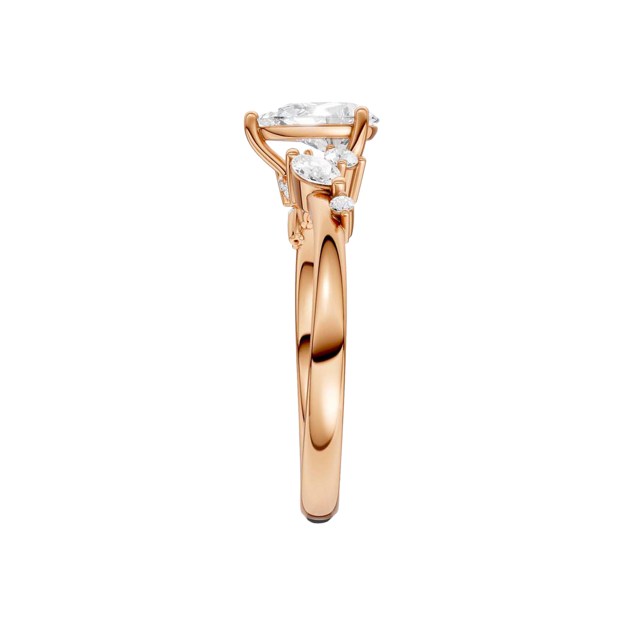 A side-profile view of a 14K rose gold ring, showing the graceful setting of the three gems.